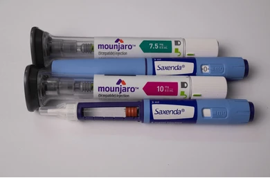 Set of diabetic/weight‑loss injectable pens laid on a white surface, including Mounjaro and Saxenda brands.