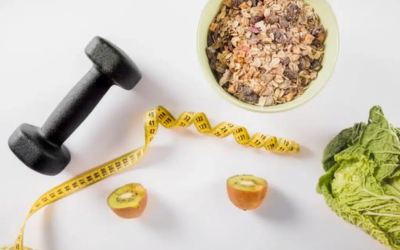 â___Metabolic recalibration Dumbbell and yellow measuring tape laid out with a bowl of granola, two kiwi halves, and leafy greens on a white surface, signaling health and fitness.